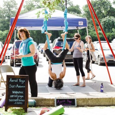 Aerial Yoga San Antonio sharing their love of the hammock and a few favorite poses to Yoga Day participants. Photo by Stacey Anne Photography